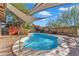 Inviting kidney-shaped swimming pool with shade sail at 4747 E Covina St, Mesa, AZ 85205