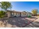 Tan house with a landscaped yard, walkway, and a partial street view at 5209 W Mauna Loa Ln, Glendale, AZ 85306