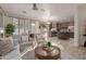 Open concept living room with kitchen view, neutral tones, and ample sunlight at 563 E Krista Way, Tempe, AZ 85284