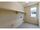 Bright laundry room with tile flooring and ample shelving at 5726 N 188Th Ln, Litchfield Park, AZ 85340