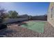 Landscaped backyard with gravel and artificial turf at 6753 W Southgate Ave, Phoenix, AZ 85043