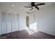 Bedroom with ceiling fan and double door closet at 7606 N 45Th Dr, Glendale, AZ 85301