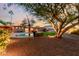 Inviting pool area with lush landscaping and charming outdoor accents at 7656 E Aster Dr, Scottsdale, AZ 85260