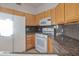 Bright kitchen featuring wood cabinets and granite countertops at 7887 N 16Th St # 230, Phoenix, AZ 85020