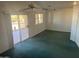 Spacious living room with carpet and sliding glass doors at 9190 W Wenden Dr, Arizona City, AZ 85123