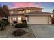 Two-story house with a tile roof, attached garage, and landscaping at 10617 W Daley Ln, Peoria, AZ 85383