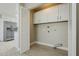 Laundry closet with built-in cabinets and shelving at 10807 W Cameo Dr, Sun City, AZ 85351