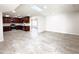 Kitchen with dark wood cabinets and tile floor at 10956 W Meade Dr, Sun City, AZ 85351