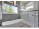 Spa-like bathroom with soaking tub, walk-in shower, and patterned tile at 1312 E Coyote Pass -- # 186, Carefree, AZ 85377