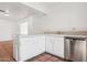 White kitchen with stainless steel dishwasher and a breakfast bar at 17807 N 10Th Ave, Phoenix, AZ 85023