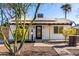 White house with solar panels, landscaping, and a paved walkway at 2205 N 22Nd St, Phoenix, AZ 85006