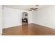 Living room with wood-look floors, ceiling fan, and view into dining area at 2527 N 61St Ave, Phoenix, AZ 85035