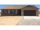 Ranch style home with tile roof, stone accents, and a two-car garage at 25883 W Denver Hills Dr, Wittmann, AZ 85361