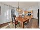 Dining room with a wooden table, four chairs, and a chandelier at 3926 E Potter Dr, Phoenix, AZ 85050