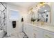 Modern bathroom with marble vanity, double sinks, and gold fixtures at 4015 E Catalina Dr, Phoenix, AZ 85018