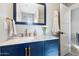 Bathroom with navy vanity, marble countertop and gold accents at 4015 E Catalina Dr, Phoenix, AZ 85018