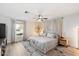 Spacious bedroom with large bed, ceiling fan, and natural light at 4015 E Catalina Dr, Phoenix, AZ 85018
