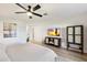 King bedroom with large TV, ceiling fan and plenty of light at 4015 E Catalina Dr, Phoenix, AZ 85018