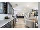 Stylish kitchen with dark cabinetry, marble countertops, and wine fridge at 4015 E Catalina Dr, Phoenix, AZ 85018