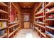 Custom-built wine cellar with extensive shelving and storage at 6301 E Huntress Dr, Paradise Valley, AZ 85253