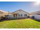 Backyard view of home with grassy area and patio at 680 E Gail Dr, Chandler, AZ 85225