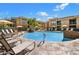 Inviting community pool with lounge chairs and umbrellas at 6900 E Princess Dr # 1219, Phoenix, AZ 85054