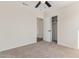 Well-lit bedroom with carpet flooring, ceiling fan, and closet at 8568 W Sanna St, Peoria, AZ 85345