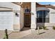 Inviting entryway with a wood door and neutral color scheme at 9550 E Plana Ave, Mesa, AZ 85212