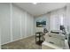 Home office with wood desk, built-in shelving, and large window at 9550 E Plana Ave, Mesa, AZ 85212