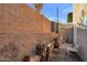 Small backyard with raised planter boxes, brick wall, and patio furniture at 10015 N 14Th St # 7, Phoenix, AZ 85020
