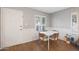 Small dining area with white table and chairs, hardwood floors, and white door at 10015 N 14Th St # 7, Phoenix, AZ 85020
