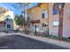 Tan two-story stucco building with arched windows, a small patio, and landscaping at 10015 N 14Th St # 7, Phoenix, AZ 85020