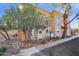Front view of a two-story stucco home with arched windows and a small front patio at 10015 N 14Th St # 7, Phoenix, AZ 85020