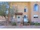Two-story stucco home with arched windows, a small patio, and well-maintained landscaping at 10015 N 14Th St # 7, Phoenix, AZ 85020