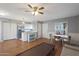 Open living room and kitchen area with hardwood floors and a ceiling fan at 10015 N 14Th St # 7, Phoenix, AZ 85020