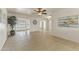 Living room with tile floors, ceiling fan, and large windows at 10521 W Prairie Hills Cir, Sun City, AZ 85351