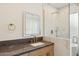 Elegant bathroom features a vanity with gold faucet and marble shower at 10587 E Caron St, Scottsdale, AZ 85258