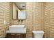 Stylish powder room with geometric wallpaper and modern sink at 10587 E Caron St, Scottsdale, AZ 85258