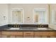 Modern bathroom with double vanity and dark countertop at 10587 E Caron St, Scottsdale, AZ 85258