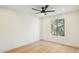 Light and airy bedroom with hardwood floors and a large window at 10587 E Caron St, Scottsdale, AZ 85258