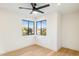 Bright bedroom with hardwood floors, ceiling fan, and window views at 10587 E Caron St, Scottsdale, AZ 85258