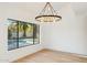 Bright dining room with hardwood floors, chandelier, and view of pool at 10587 E Caron St, Scottsdale, AZ 85258