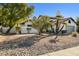 White stucco house with a red tile roof and gravel landscaping at 10587 E Caron St, Scottsdale, AZ 85258