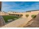 Artificial turf backyard with stone pathway and block wall at 11899 N Spearfish St, Surprise, AZ 85388