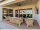 Relaxing patio with wicker furniture and sliding glass doors at 11899 N Spearfish St, Surprise, AZ 85388