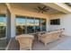 Covered patio with wicker furniture and view into the living room at 11899 N Spearfish St, Surprise, AZ 85388