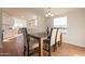 Bright dining room adjacent to kitchen with wood table and chairs at 16036 N 70Th Dr, Peoria, AZ 85382