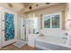 Relaxing bathroom with soaking tub and walk-in shower at 21836 W Hopi St, Buckeye, AZ 85326