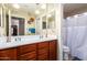 Well-lit bathroom with double vanity and shower at 21836 W Hopi St, Buckeye, AZ 85326