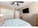 Bright bedroom with double doors and ceiling fan at 21836 W Hopi St, Buckeye, AZ 85326